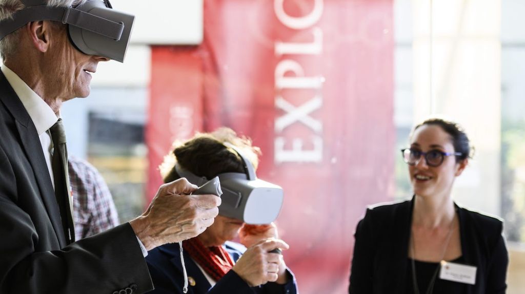 Dr. Schloss guiding Gov Tony Evers in a VR exercise