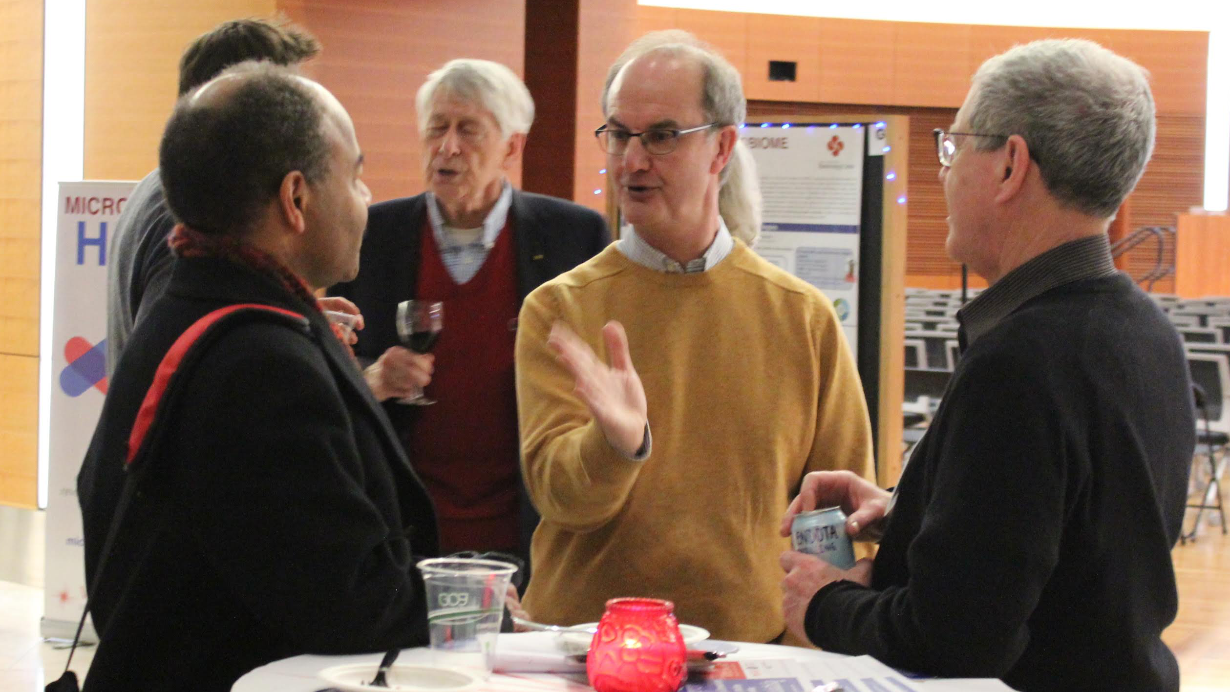 Michael Ferris speaks to guests at the Discovery Building including Eric Wilcots.