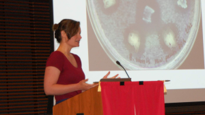 AManda hurley giving a talk at a lectern