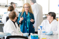 Jo Handelsman (center), director of WID, talks with instructors from eight UW System schools and more than a dozen other colleges and universities