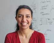 Portrait of Claudia Solís-Lemus, a plant pathology professor at UW–Madison, smiling in a professional headshot with a blurred academic setting in the background.