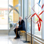 John D. Wiley sitting on the Casey bench during the opening reception