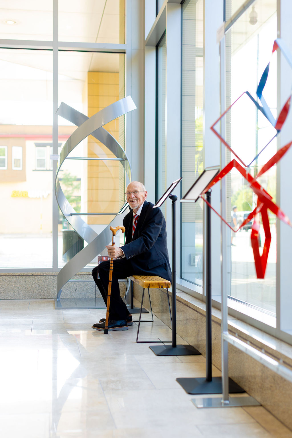 John D. Wiley sitting on the Casey bench during the opening reception