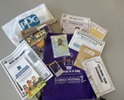 Contents of tantalizingly fun science experiments are laid out on top of a draw string bag.