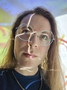 Bryce Sprecher in the CAVE with light playing over their face