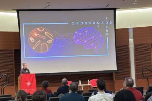 Sam Mulrooney introducing the speakers at Feb 2025 Crossroads of Ideas