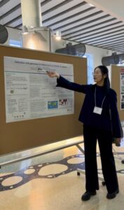 Nan explaining a poster at a symposium