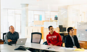 John Yin in a meeting with grad students