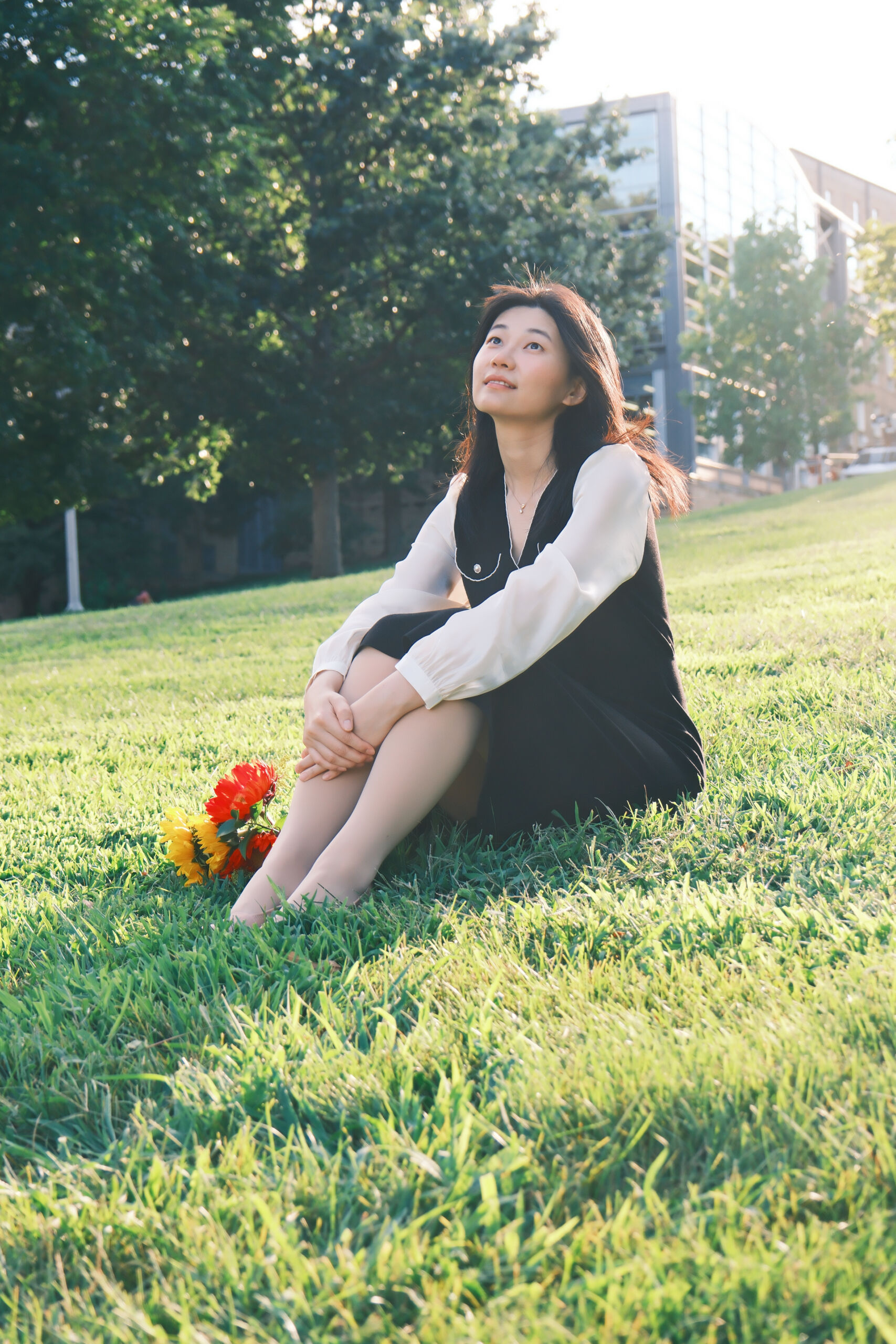 Nan Jiang sitting on grass