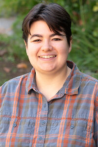 Lauren Pratt Lauren Pratt portrait. Woman with short dark hair wearing a plaid shirt.