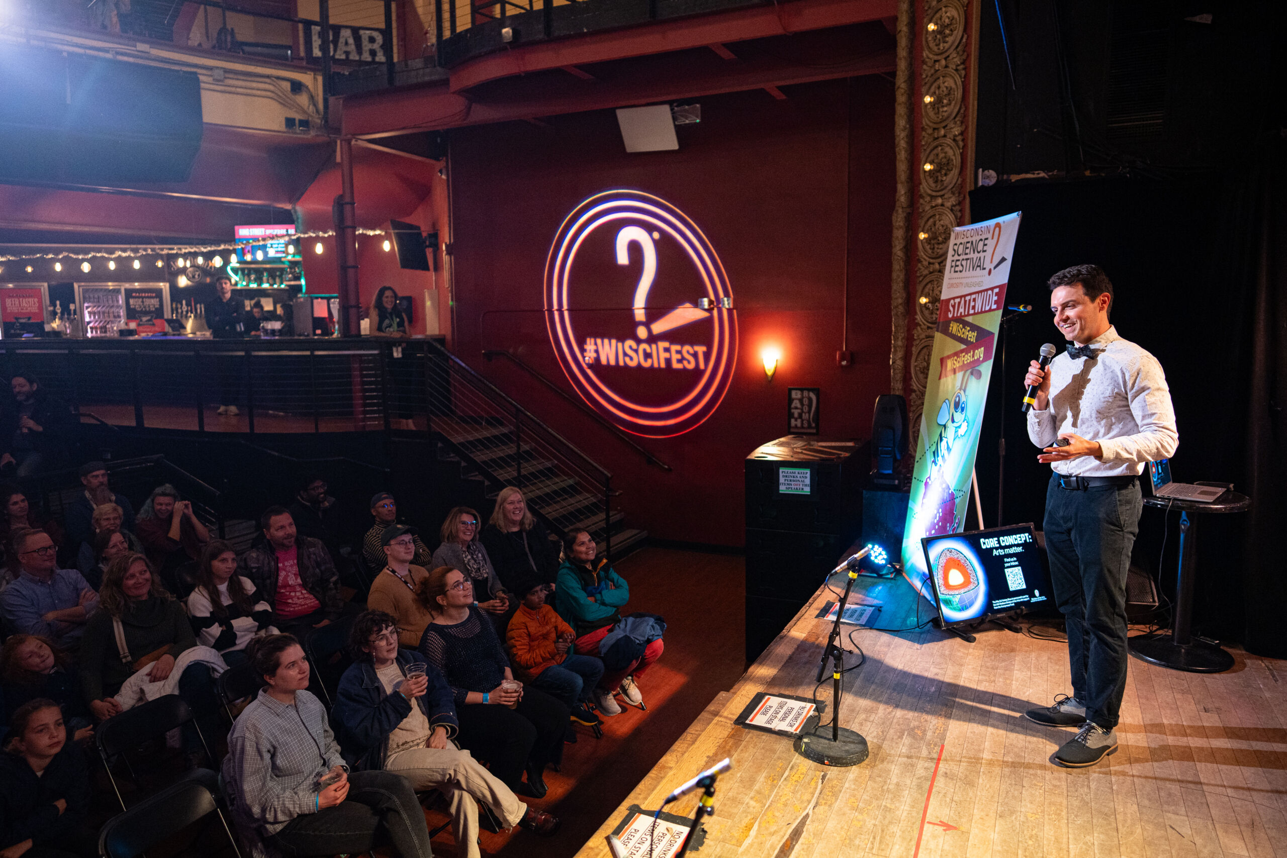 Ben Rush hosting the WhySci Variety show 2025