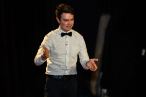 Ben Rush emcee-ing the Why Sci fest 2025