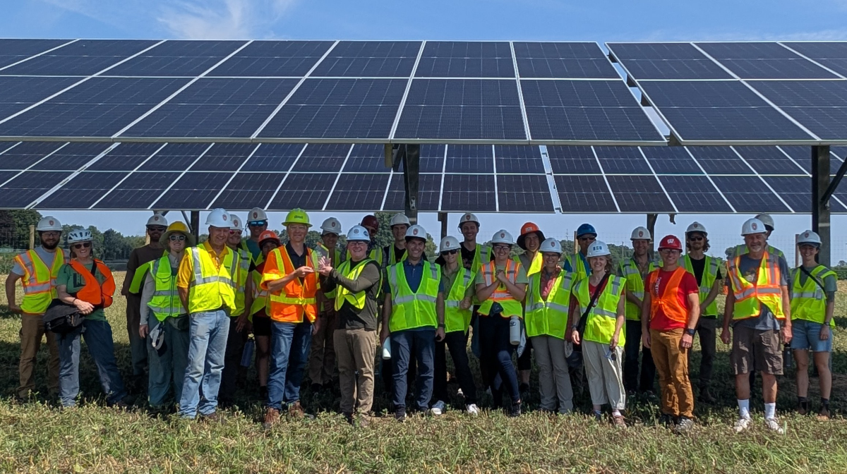 Badgervoltaics group photo in front of a large solar array